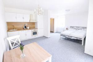 a kitchen and living room with a table and a couch at The Meetinka - Peaceful Stay, Jeseníky in Jeseník