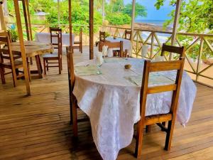 a table with a white table cloth on a deck at appartment émeraude in Kribi +4 photos
