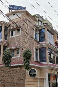a building with a street sign on top of it at Whitestone Inn in Guwahati