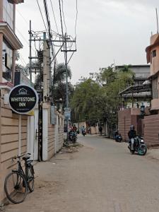 a bike parked on the side of a street at Whitestone Inn in Guwahati