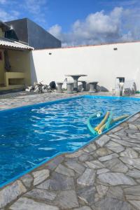 a pool with a slide in the water at Pousada Morada dos Guarás in Ilha Comprida