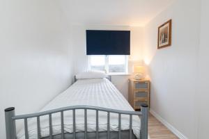 a small bedroom with a bed and a window at Valley View in Shield Row