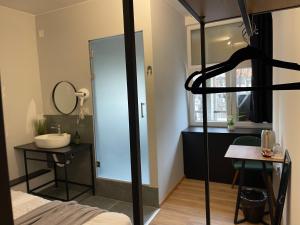 a bathroom with a sink and a mirror at E - Central Room Five in Skopje