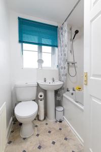 a white bathroom with a toilet and a sink at Valley View in Shield Row +18 photos