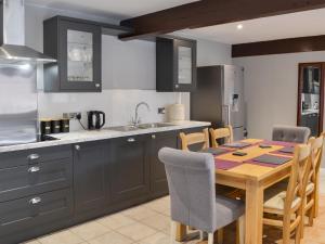 a kitchen with a wooden table and a dining room at Koi Keep - Ukc1909 in Doddington