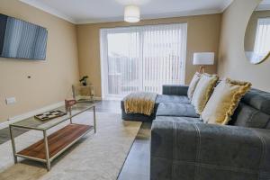 a living room with a couch and a table at Dunward House in Livingston