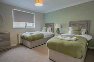 a bedroom with two beds and a window at Dunward House in Livingston