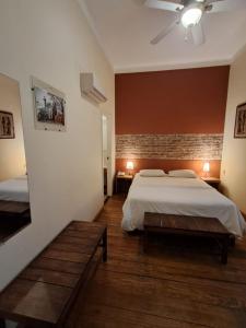a bedroom with two beds and a brick wall at Le Vrero Boutique Hotel in Colonia del Sacramento