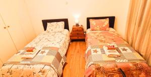 a bedroom with two beds and a table with a night stand at Sea view house II in Dhílesi
