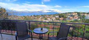 a table and chairs on a balcony with a view at Sea view house II in Dhílesi