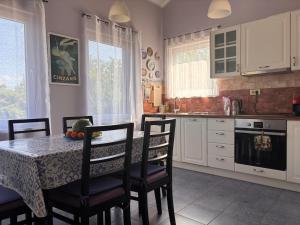 a kitchen with a table with chairs and a table and a table at Patrick House in Tivat