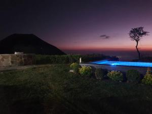 a swimming pool in a yard at night at Sueño Verde EcoVilla in Cerro Verde