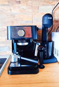 a coffee maker sitting on top of a table at Sea view house II in Dhílesi