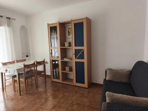 a living room with a couch and a table at Blue Apartment in Portimão