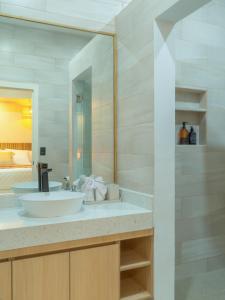 a bathroom with a sink and a large mirror at Miradora House in El Sunzal +21 photos