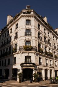 a white building with plants on the front of it at Hotel de Nell in Paris