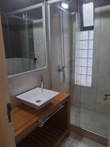 a bathroom with a sink and a shower at Le Vrero Boutique Hotel in Colonia del Sacramento +65 photos