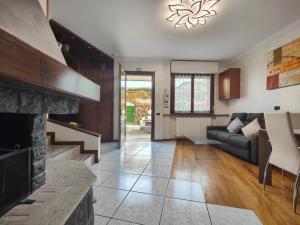 a living room with a couch and a fireplace at Lavilletta stanza parco in Baranzate