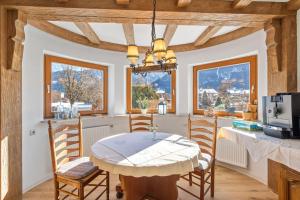 a kitchen with a table and chairs in a room at Gästehaus Florian in Grainau +11 photos