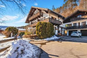 a house with a car parked in front of it at Gästehaus Florian in Grainau