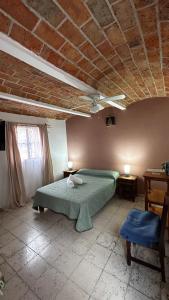 ein Schlafzimmer mit einem grünen Bett und einer Decke in der Unterkunft Casa Ttorrez in San Miguel de Allende + 25 Fotos