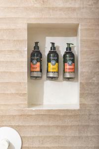 a wall with two soap dispensers on it at Hotel Alma in Tinjacá