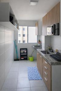 a kitchen with a sink and a counter top at Ilha Aruba Condomínio na Cohama próx a praia in São Luís +9 photos
