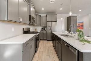 a kitchen with white counters and stainless steel appliances at Zion Adventure townhouse in Hurricane