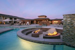 a pool with a fire pit in the middle at Zion Adventure townhouse in Hurricane