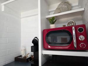 a red microwave in a shelf in a kitchen at Sequoia Village in Three Rivers +76 photos