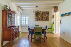 a dining room with a table and blue chairs at Cactus Adobe in Twentynine Palms +21 photos