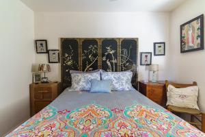 a bedroom with a bed with a colorful bedspread at Cactus Adobe in Twentynine Palms