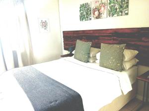 a bedroom with a bed and a headboard at Sea Breeze Manor - Sage Unit in East London