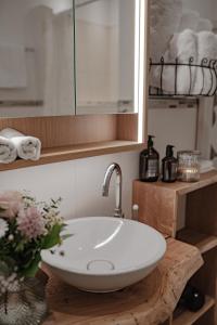 a bathroom with a white sink and a mirror at Landgut zur Mühle in Dorfen +71 photos