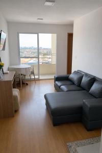 a living room with a couch and a table at Ilha Aruba Condomínio na Cohama próx a praia in São Luís