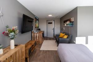 a living room with a bed and a couch at Uno Carbis Bay - Boutique Luxury Accommodation in Carbis Bay