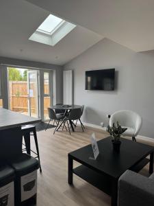a living room with a couch and a table and chairs at Ravenscourt House in Bristol