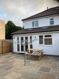 a house with a picnic table and a bench at Ravenscourt House in Bristol