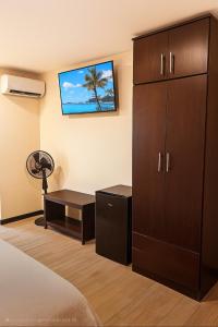 a bedroom with a large cabinet and a desk at Hotel Boutique 4 Estancias in San Ramón