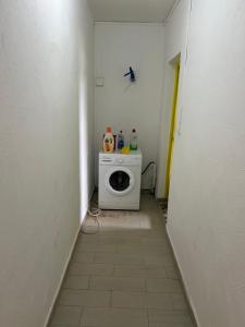 a small bathroom with a washing machine in a room at AMI House I in Mamoudzou +6 photos
