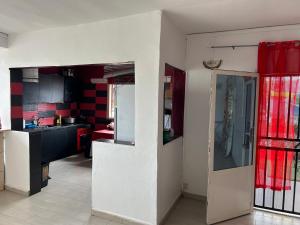 a kitchen with red and white walls and a refrigerator at AMI House I in Mamoudzou
