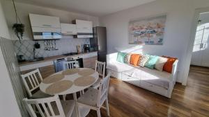 a kitchen and a dining room with a table and a couch at Mediterranean House - Forest Marjan in Split