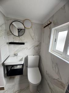 a bathroom with a toilet and a sink and a mirror at Cascais Garden House 102 in Cascais