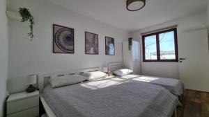 a bedroom with two beds and a window at Mediterranean House - Forest Marjan in Split
