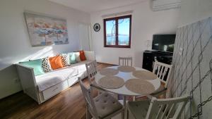 a living room with a table and a couch at Mediterranean House - Forest Marjan in Split