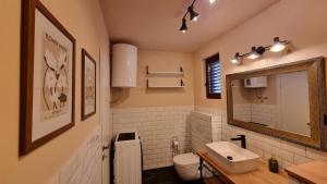 a bathroom with a sink and a toilet and a mirror at Mediterranean House - Forest Marjan in Split +16 photos