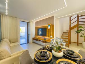 a living room with a couch and a table at Duplex com Piscina Privativa em Itacimirim! in Camaçari