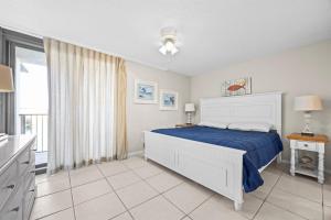 a white bedroom with a bed and a window at Wind Drift North 214 2BD, 2BA in Orange Beach