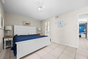 a bedroom with a bed with a blue comforter at Wind Drift North 214 2BD, 2BA in Orange Beach