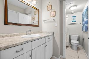 a bathroom with a sink and a toilet at Wind Drift North 214 2BD, 2BA in Orange Beach +20 photos